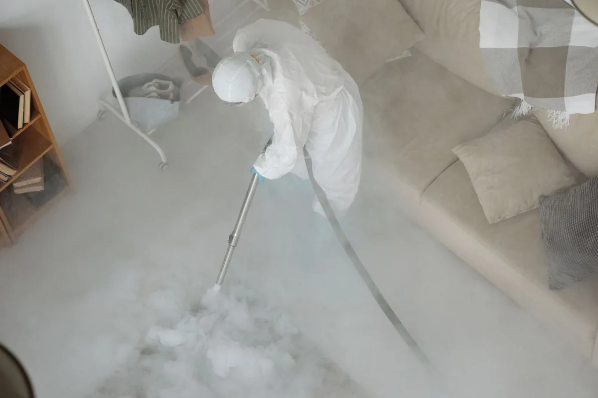 Biohazard cleanup technician in protective equipment, Walls, MS